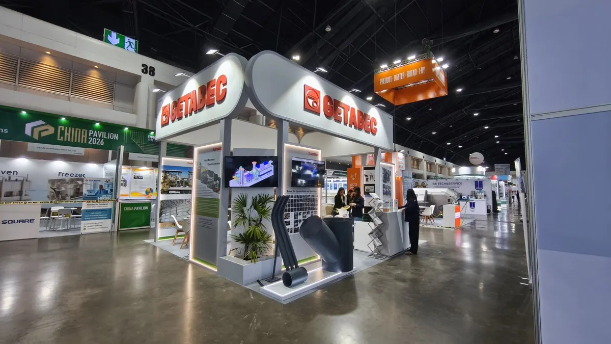 Booths across a bright exhibition aisle